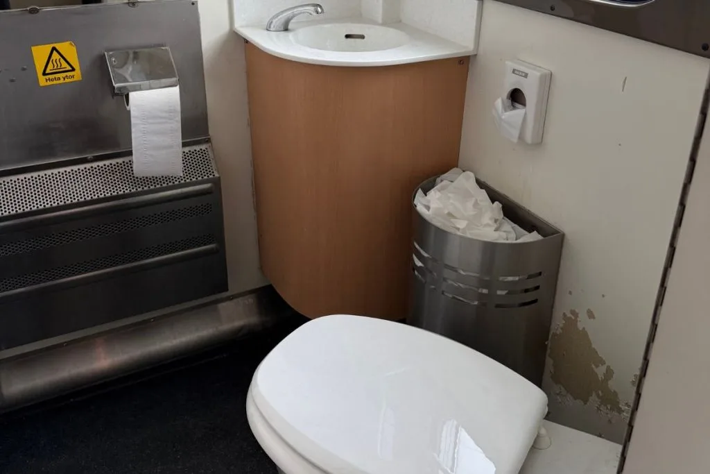 Compact toilet with sink at the end of the couchette car on the SJ night train to Stockholm