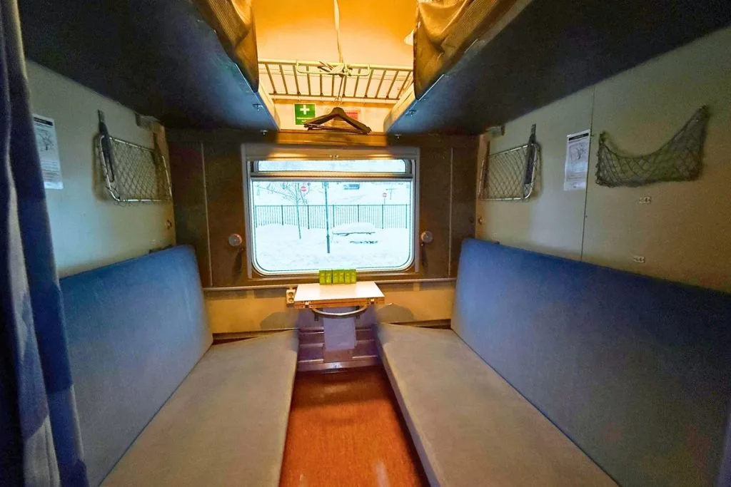 Inside a private six-berth couchette on the Narvik sleeper train to Stockholm, snow outside the window