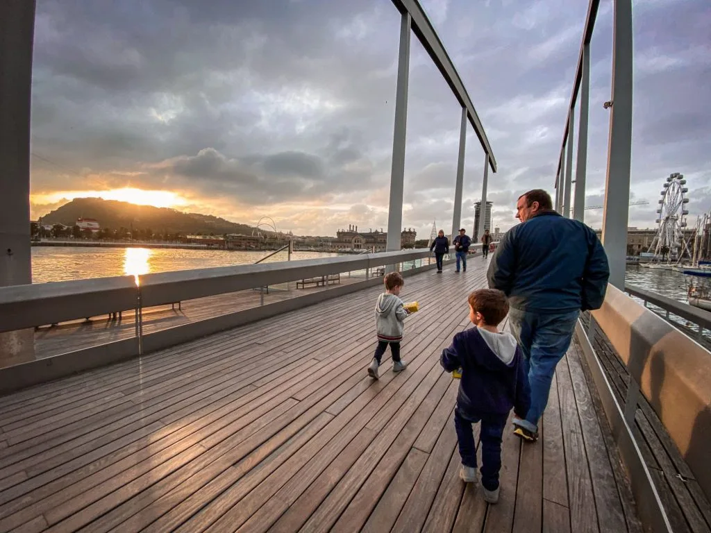 Only One Carry On Travel advice for couples, families, parents with twins, military living over seas. For real people with limited time and money. Toddler twins on Barcelona boardwalk.