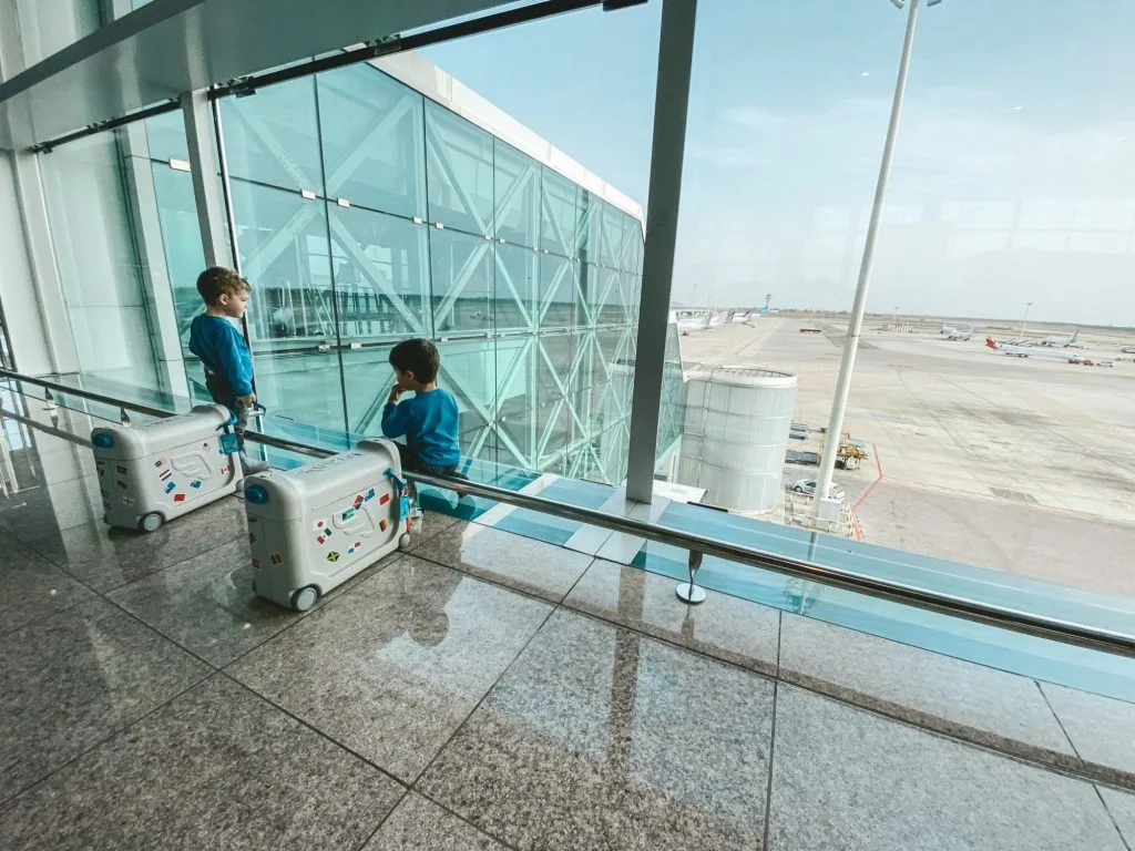 Only One Carry On Travel advice for couples, families, parents with twins, military living over seas. For real people with limited time and money. Twin kids at airport in Barcelona.
