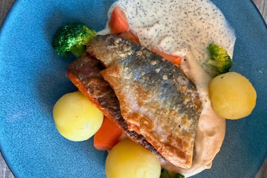 Crispy-skin Arctic char with potatoes and vegetables at Restaurant Fiskekroken in Narvik