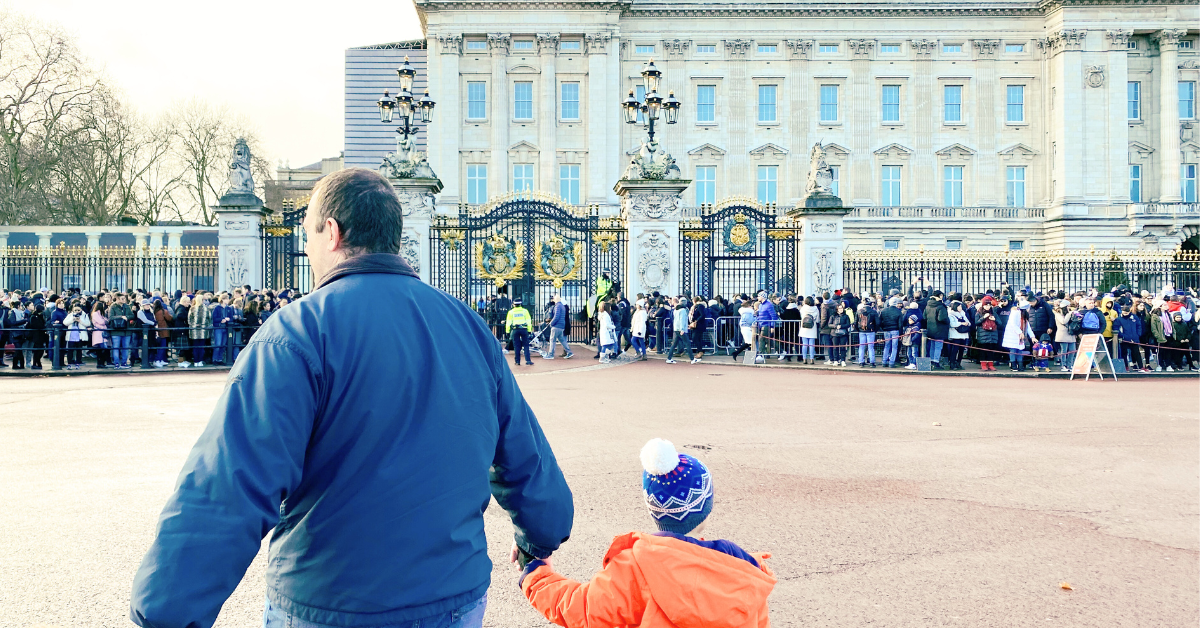 Father and Son walking past Buckingham palace after the changing of the guard