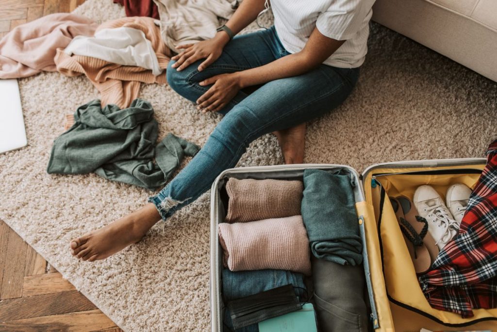 How to roll clothes for packing: jeans rolled with t-shirt inside for space-saving weekend travel