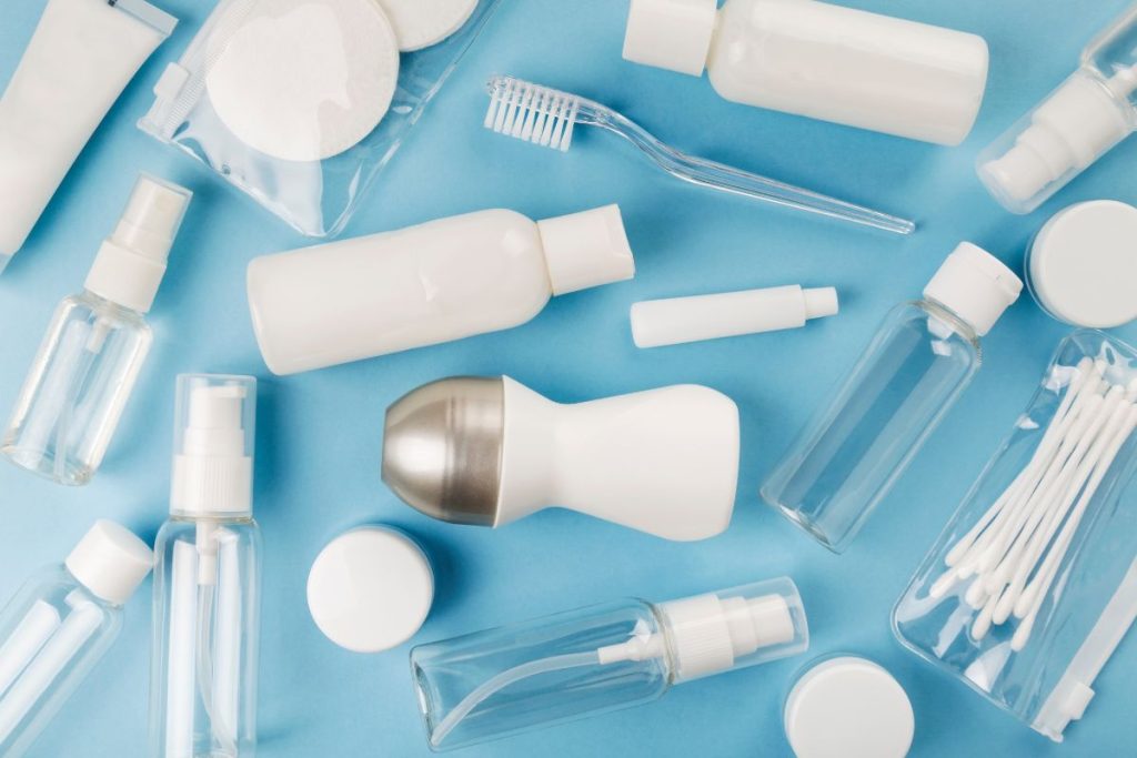 Minimalist travel toiletries including solid shampoo bar and travel sizes for packing weekend trip in backpack