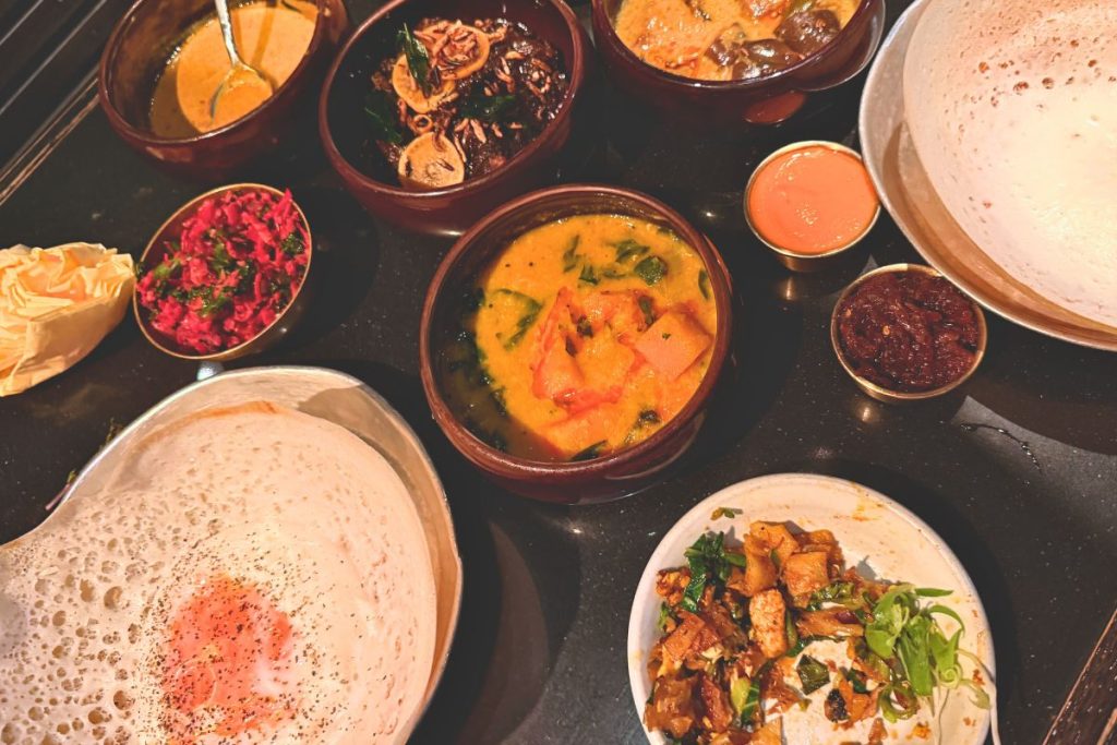 Family of 4 dining at Hoppers London - Michelin recommended Sri Lankan restaurant included in London budget breakdown