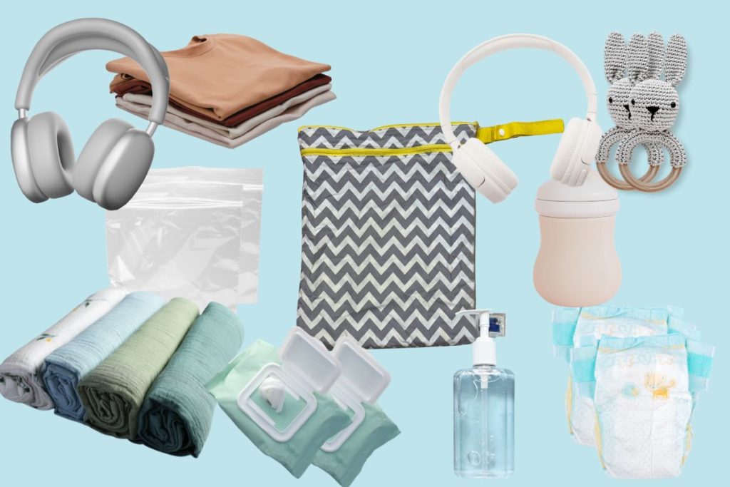 Flat lay of essential items for flying with twins including wet-dry bags, emergency kits, headphones, and bonus travel items
