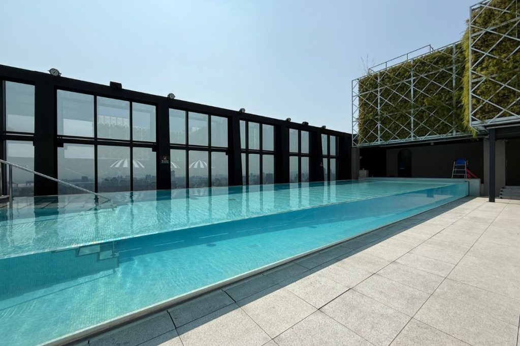 Le Méridien Taichung rooftop glass pool with city views and glass panel walls you can see through