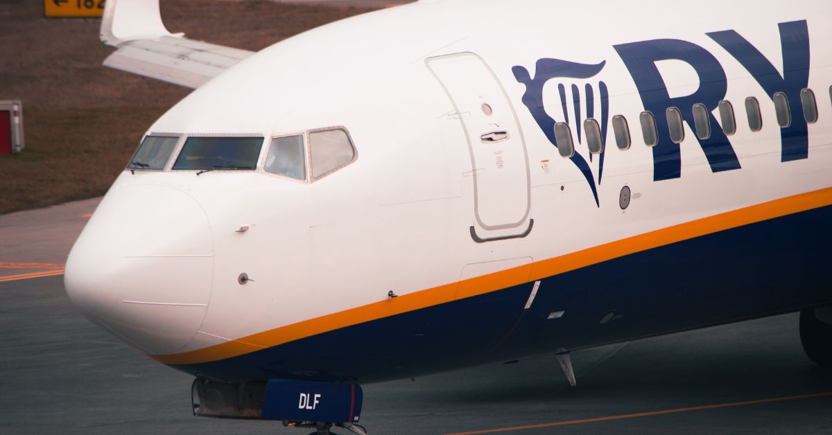Ryanair plane boarding at European secondary airport showing budget airline travel