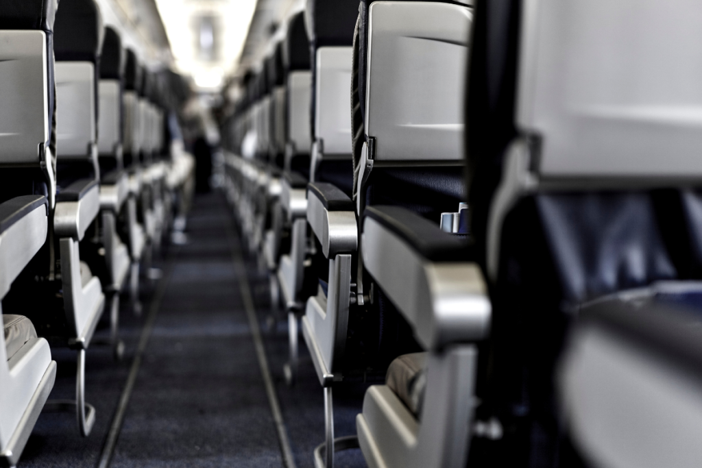 Baby playing with airplane armrest — free entertainment for infants on flights
