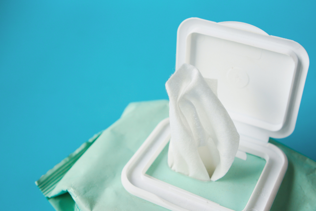 Baby playing with empty wipes container on plane — free baby entertainment on flights