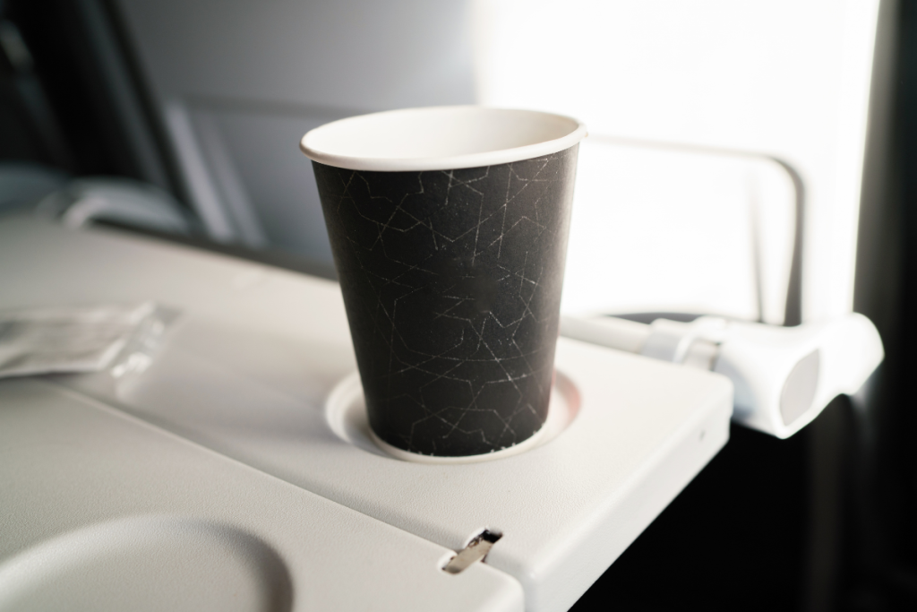 aby stacking plastic cups on airplane tray table — free entertainment for infants