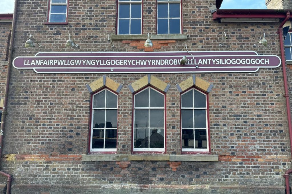 Llanfairpwllgwyngyll train station sign Anglesey Wales β longest place name in Europe