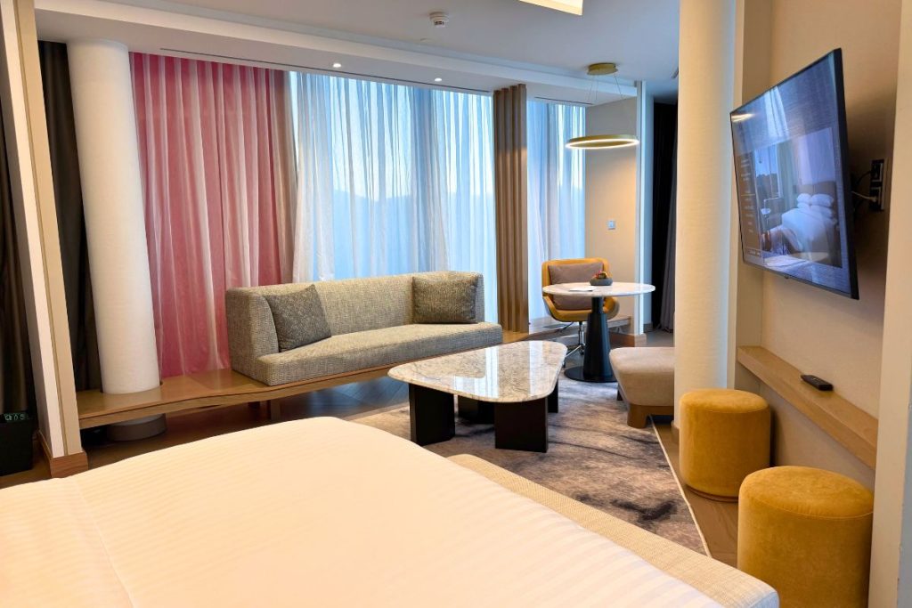 Premier Suite bedroom at the Tirana Marriott with floor-to-ceiling windows and city views