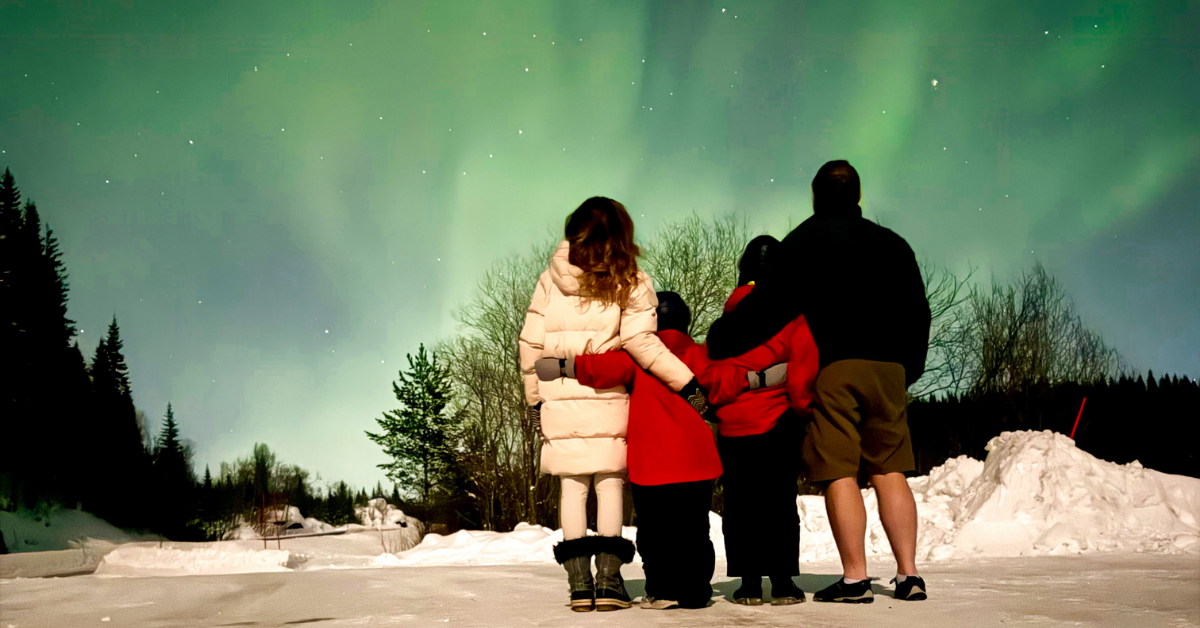 Family watching the Narvik northern lights with kids at a roadside layby